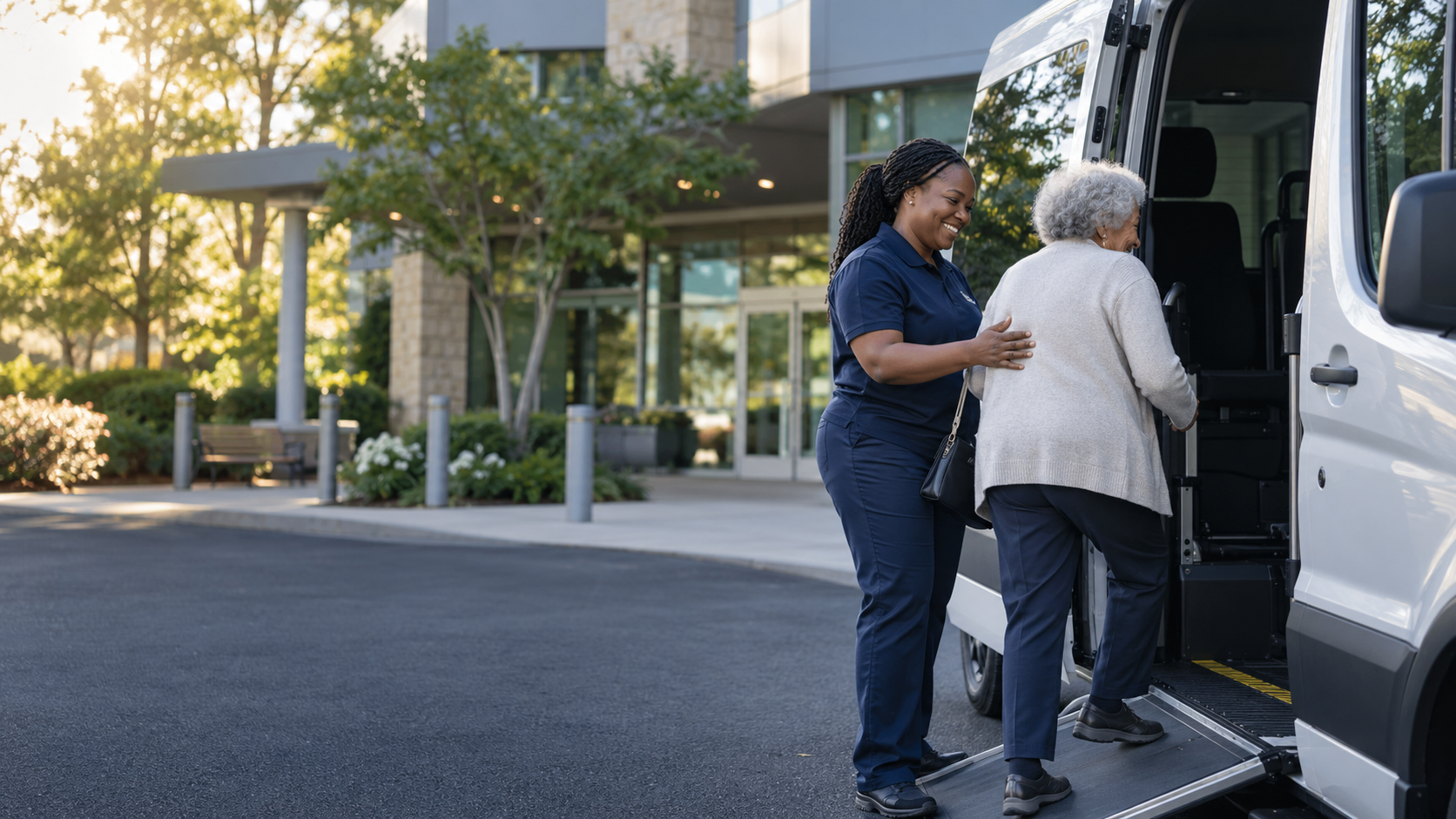 A professional driver assisting an older passenger into an accessible transportation van outside a healthcare facility